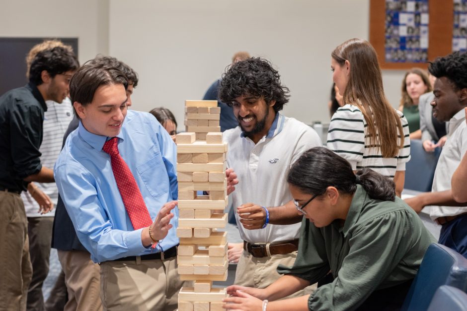 Council Members playing Jenga for a Wednesday meeting speaker demonstration